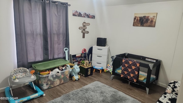 game room featuring baseboards and wood finished floors
