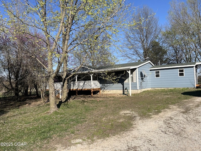 exterior space with a wooden deck and a front yard
