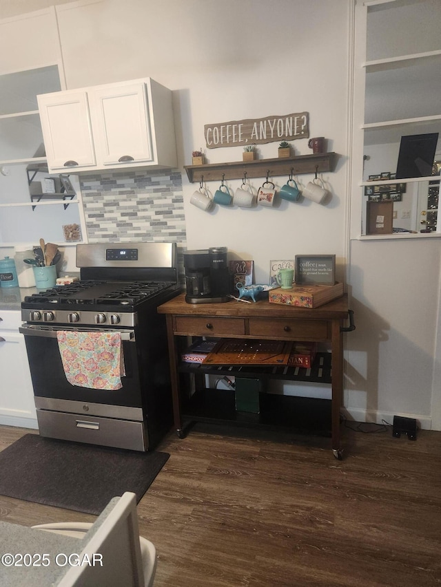 kitchen featuring open shelves, stainless steel gas range oven, dark wood-type flooring, white cabinetry, and tasteful backsplash