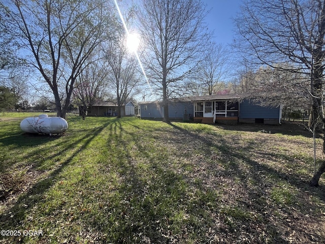 view of yard featuring a sunroom