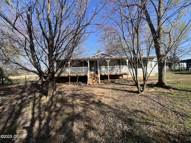 rear view of property with covered porch