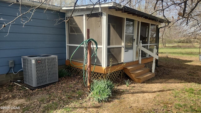 view of outdoor structure featuring central AC unit and entry steps