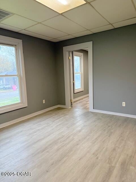201 N Georgia St, Pittsburg, KS 66762 - unfurnished room featuring a paneled ceiling, baseboards, and light wood-style flooring
