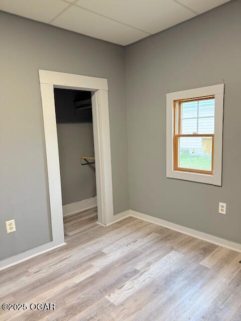 201 N Georgia St, Pittsburg, KS 66762 - unfurnished bedroom with wood finished floors, baseboards, and a closet