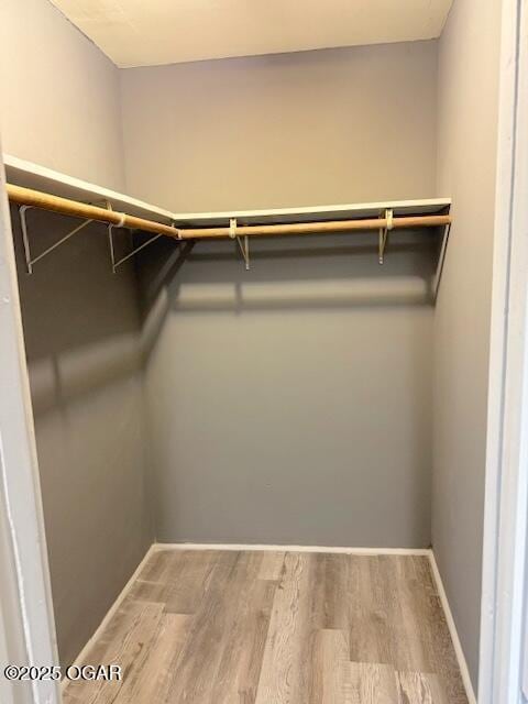 201 N Georgia St, Pittsburg, KS 66762 - walk in closet featuring wood finished floors
