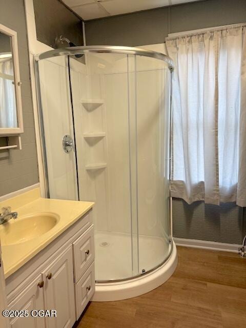 201 N Georgia St, Pittsburg, KS 66762 - bathroom featuring a shower stall, wood finished floors, and vanity