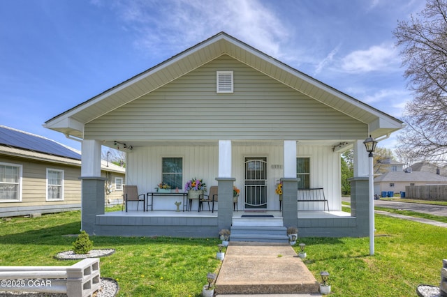 1831 Annie Baxter Ave, Joplin, MO 64804 - view of front of house featuring board and batten siding, a front lawn, and covered porch
