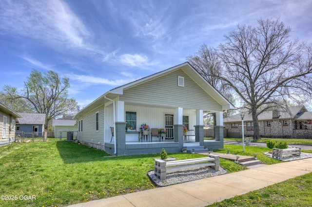 1831 Annie Baxter Ave, Joplin, MO 64804 - view of front of property featuring a front yard, central AC unit, fence, and covered porch