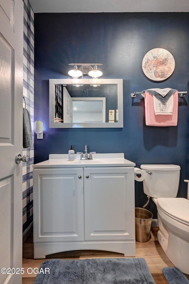 1831 Annie Baxter Ave, Joplin, MO 64804 - bathroom featuring vanity, baseboards, toilet, and wood finished floors