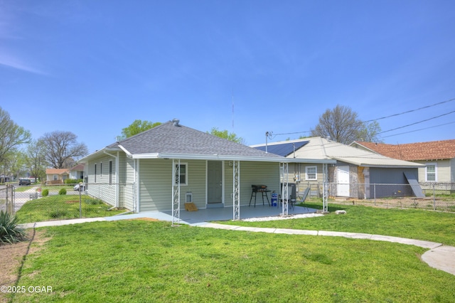 1831 Annie Baxter Ave, Joplin, MO 64804 - rear view of property with roof with shingles, a yard, a patio area, and fence