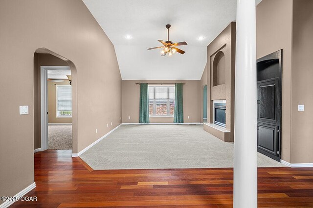 3826 W Randall St, Battlefield, MO 65619 - unfurnished living room featuring wood finished floors, a ceiling fan, a glass covered fireplace, and a wealth of natural light