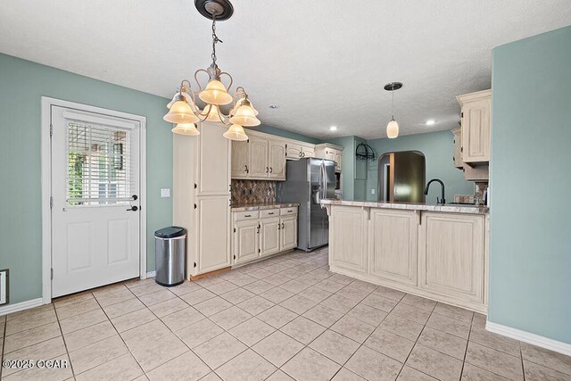 3826 W Randall St, Battlefield, MO 65619 - kitchen featuring stainless steel fridge with ice dispenser, a peninsula, cream cabinetry, a chandelier, and decorative backsplash