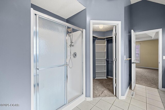 3826 W Randall St, Battlefield, MO 65619 - bathroom with a spacious closet, a shower stall, tile patterned flooring, and baseboards