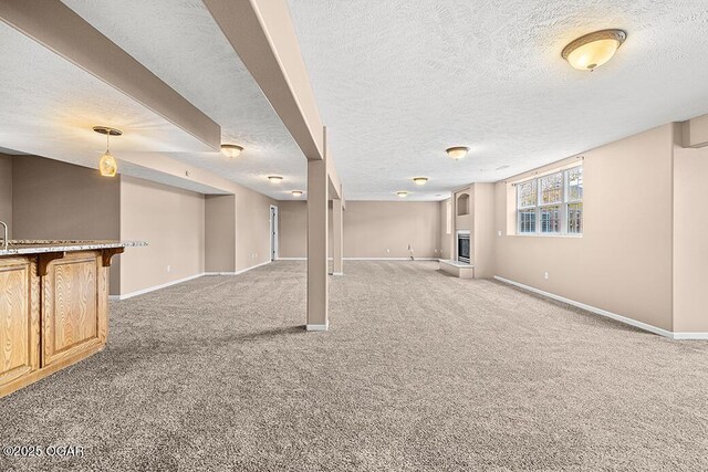 3826 W Randall St, Battlefield, MO 65619 - basement featuring bar, baseboards, light carpet, and a textured ceiling