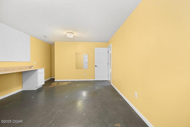 3826 W Randall St, Battlefield, MO 65619 - below grade area with a textured ceiling and baseboards