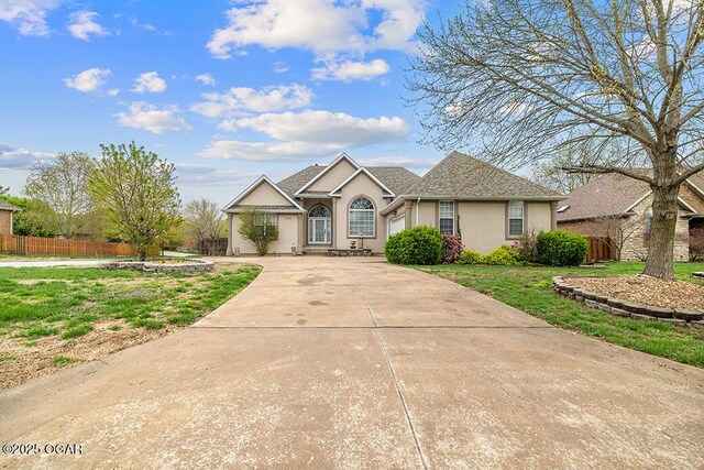 3826 W Randall St, Battlefield, MO 65619 - single story home featuring concrete driveway, stucco siding, fence, and a front yard