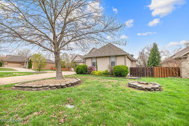 3826 W Randall St, Battlefield, MO 65619 - view of yard featuring an outdoor fire pit, fence, and concrete driveway