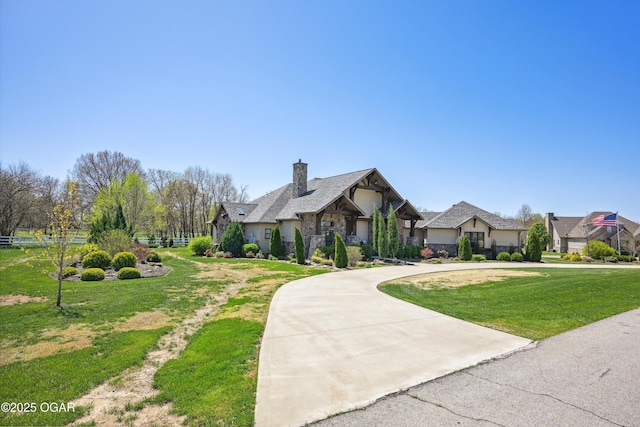 1624 Liam St, Carthage, MO 64836 - view of front of home with curved driveway, a front lawn, and a chimney