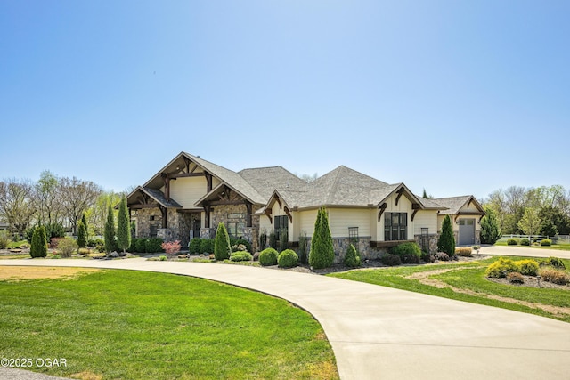 1624 Liam St, Carthage, MO 64836 - view of front of property with curved driveway, stone siding, a garage, and a front lawn