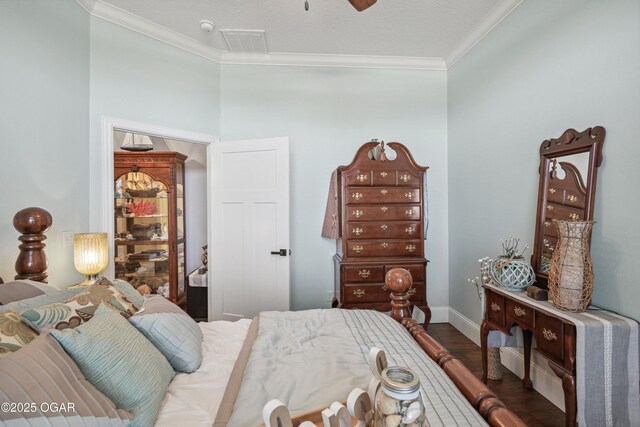 1624 Liam St, Carthage, MO 64836 - bedroom with baseboards, ornamental molding, visible vents, ceiling fan, and wood finished floors