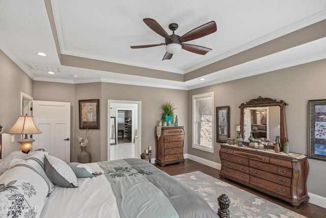 1624 Liam St, Carthage, MO 64836 - bedroom with baseboards, dark wood-style floors, crown molding, a tray ceiling, and recessed lighting