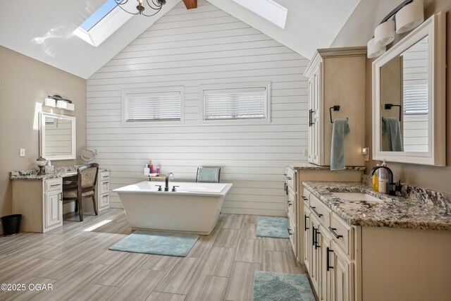 1624 Liam St, Carthage, MO 64836 - full bathroom with wooden walls, a skylight, a soaking tub, and vanity