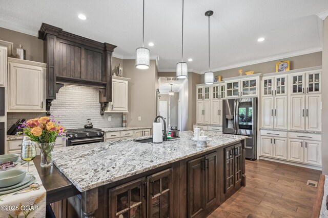 1624 Liam St, Carthage, MO 64836 - kitchen featuring stainless steel fridge with ice dispenser, a sink, dark brown cabinetry, and gas range oven