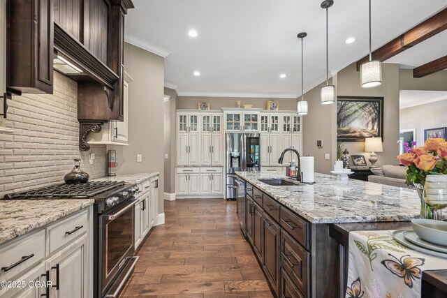 1624 Liam St, Carthage, MO 64836 - kitchen featuring a sink, dark brown cabinets, appliances with stainless steel finishes, and dark wood-style flooring