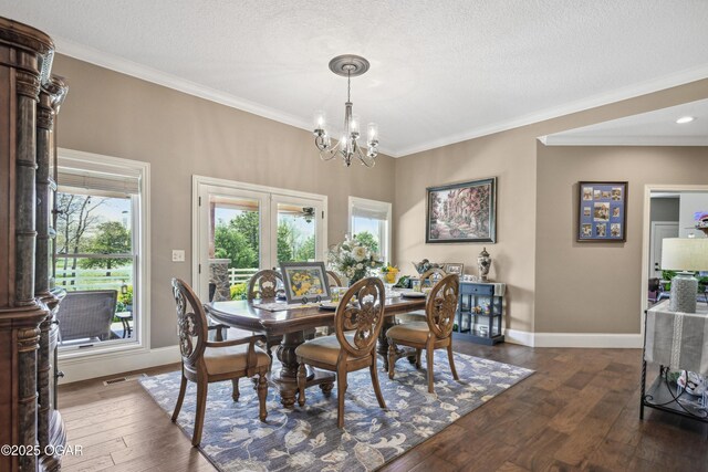 1624 Liam St, Carthage, MO 64836 - dining room featuring baseboards, a chandelier, a textured ceiling, crown molding, and dark wood-type flooring