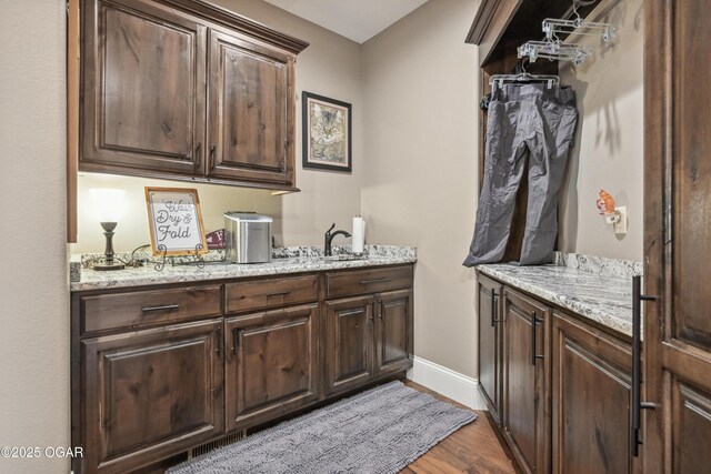 1624 Liam St, Carthage, MO 64836 - interior space with wood finished floors, a sink, baseboards, and visible vents