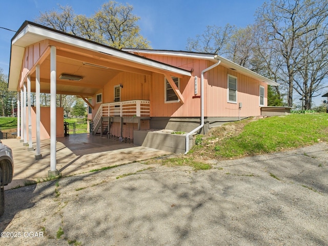 view of side of home with aphalt driveway