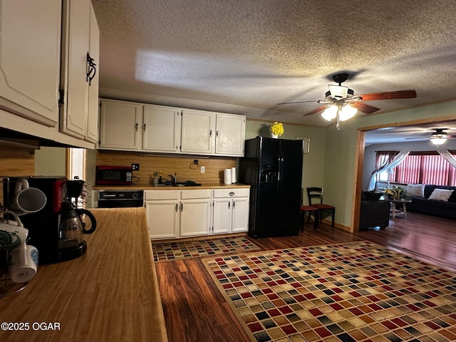 kitchen featuring ceiling fan, a textured ceiling, white cabinets, black appliances, and dark wood-style flooring