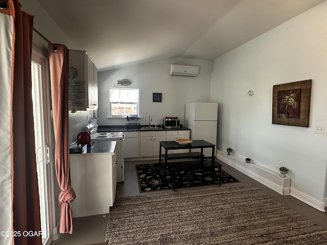 kitchen featuring white appliances, vaulted ceiling, a wall mounted AC, a sink, and dark countertops