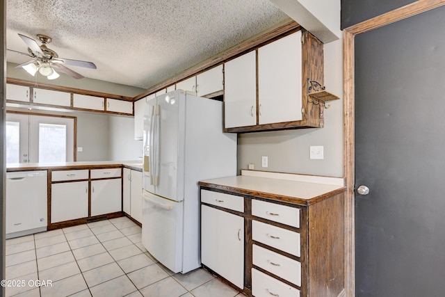 kitchen with ceiling fan, white appliances, a textured ceiling, white cabinets, and light countertops