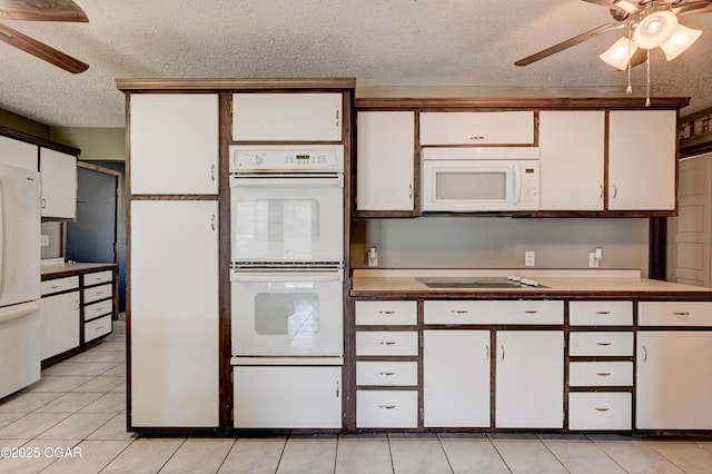 kitchen featuring a textured ceiling, ceiling fan, white appliances, and white cabinets