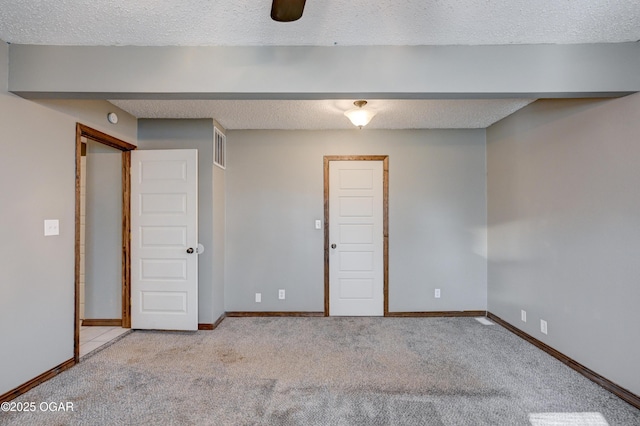 interior space featuring a textured ceiling and baseboards