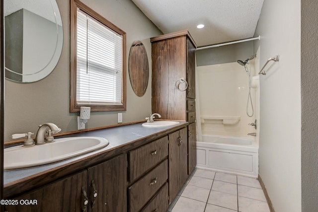 full bathroom with tile patterned flooring, double vanity, a textured ceiling, and a sink