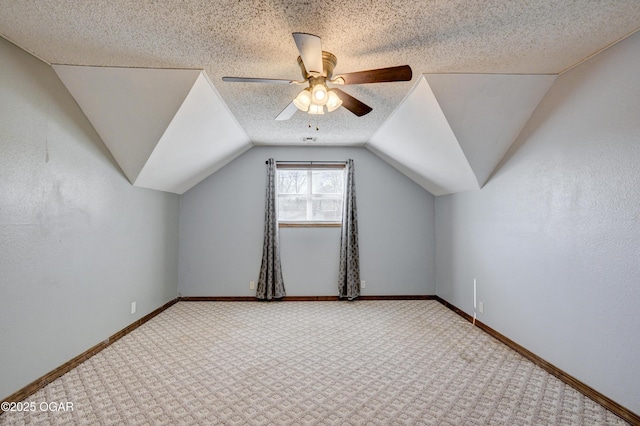 bonus room with ceiling fan, a textured ceiling, vaulted ceiling, and carpet floors
