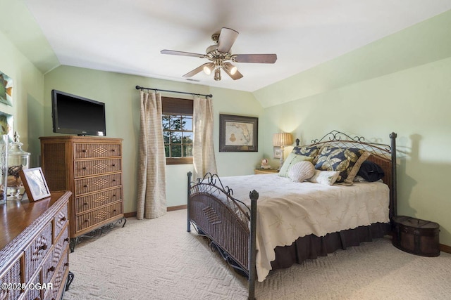 carpeted bedroom with baseboards, a ceiling fan, and lofted ceiling