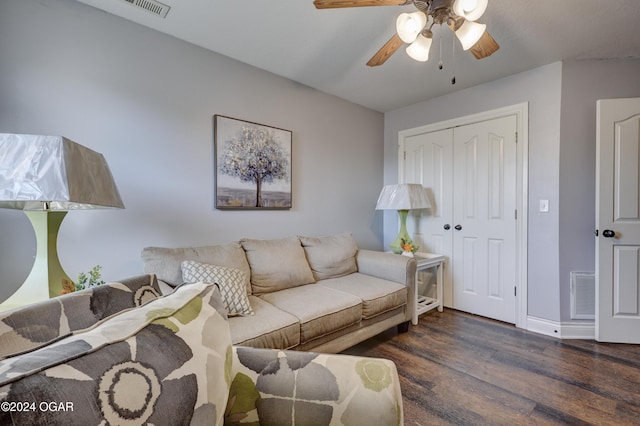 living area with visible vents, baseboards, a ceiling fan, and wood finished floors