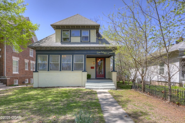 426 N Byers Ave, Joplin, MO 64801 - view of front facade with a front yard, fence, brick siding, and a shingled roof