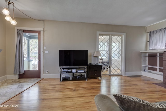 426 N Byers Ave, Joplin, MO 64801 - living area featuring baseboards, wood finished floors, and a textured ceiling