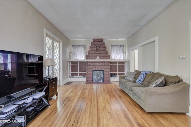 426 N Byers Ave, Joplin, MO 64801 - living room with light wood finished floors and a brick fireplace