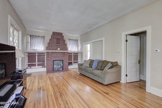 426 N Byers Ave, Joplin, MO 64801 - living area with a healthy amount of sunlight, wood finished floors, and a fireplace