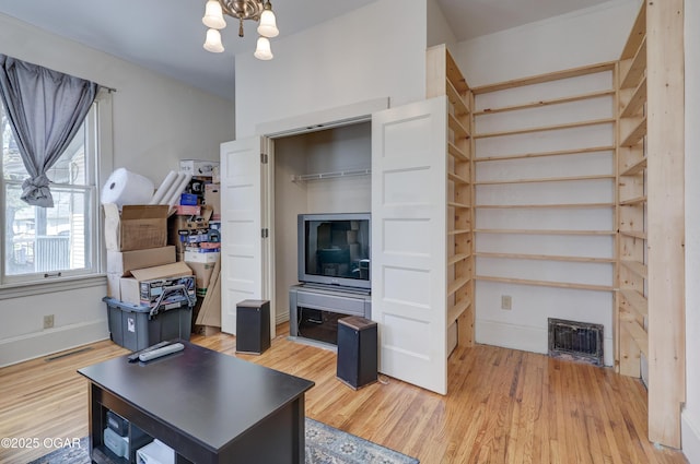 426 N Byers Ave, Joplin, MO 64801 - living room featuring light wood-style flooring, visible vents, and an inviting chandelier