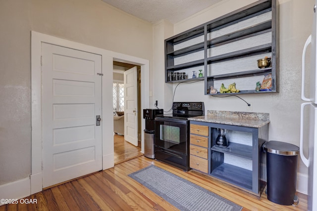 426 N Byers Ave, Joplin, MO 64801 - kitchen with black electric range, light wood-style flooring, a textured ceiling, and open shelves