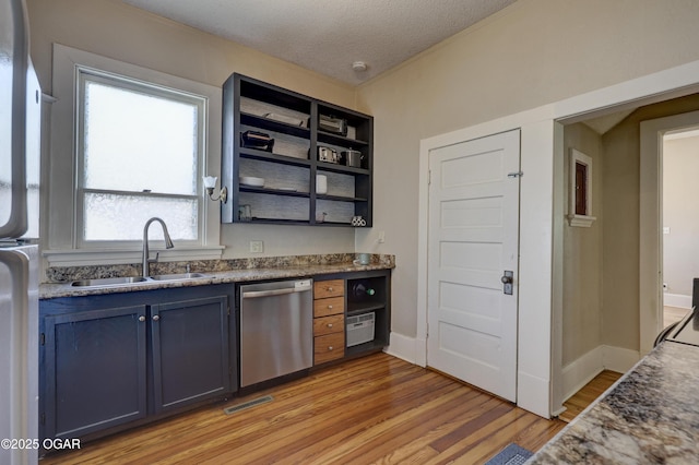 426 N Byers Ave, Joplin, MO 64801 - kitchen featuring light wood-style flooring, blue cabinetry, open shelves, appliances with stainless steel finishes, and a sink