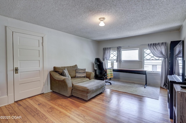 426 N Byers Ave, Joplin, MO 64801 - living area featuring light wood-type flooring and a textured ceiling