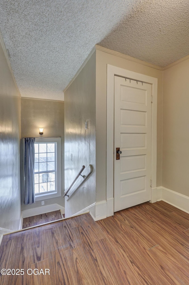 426 N Byers Ave, Joplin, MO 64801 - foyer with baseboards, a textured ceiling, ornamental molding, and wood finished floors