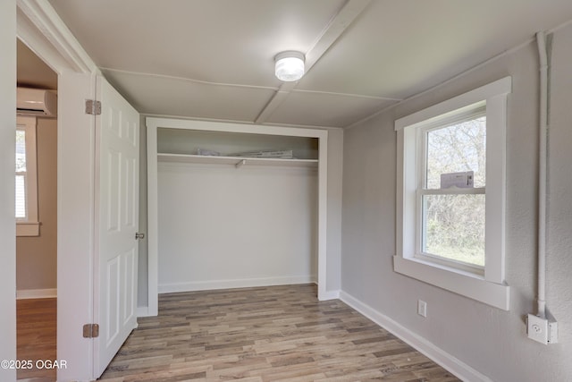 closet with a wall mounted air conditioner